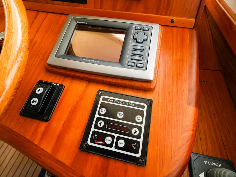Slide: The Image of Wooden boat dashboard with navigation and wiper controls, Legacy 32, 2009 model. - 24