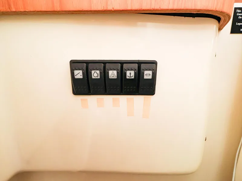 Slide: The Image of Control panel with five switches on a 2009 Legacy 32 boat. - 26