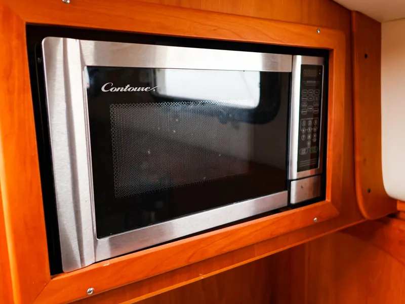 Slide: The Image of Built-in microwave in a Legacy 32, 2009 model, with wooden cabinetry. - 30