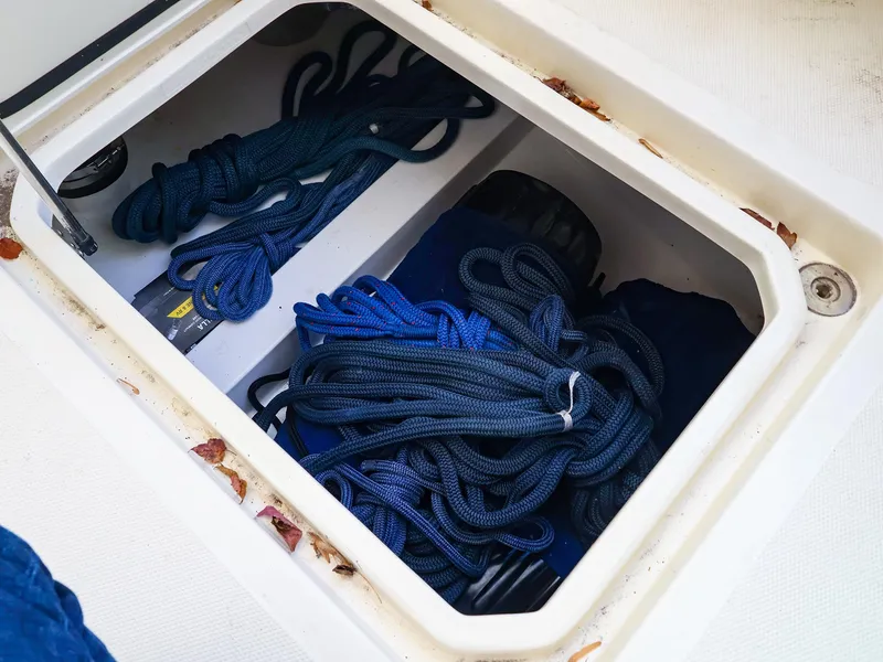 Slide: The Image of Storage compartment on a 2009 Legacy 32 boat with coiled blue ropes. - 33