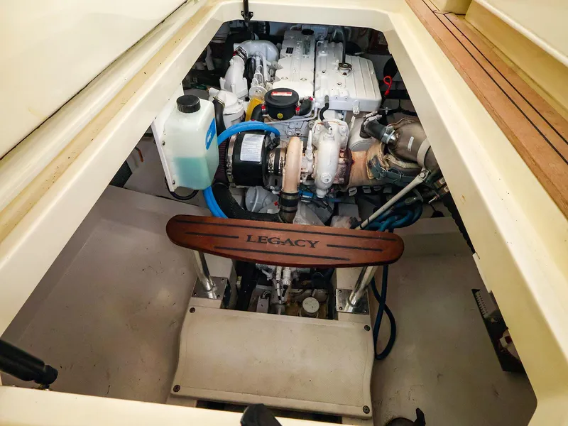 Slide: The Image of Engine compartment of a 2009 Legacy 32 boat, showcasing mechanical components and branding. - 35