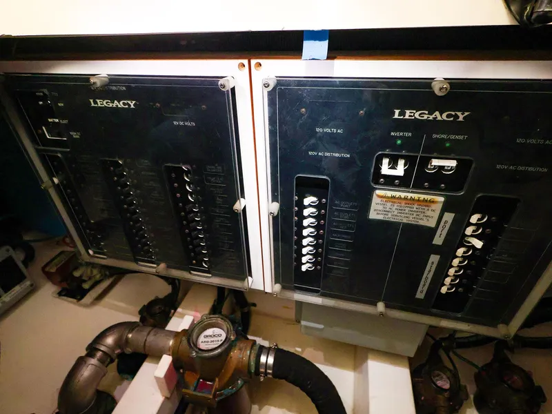 Slide: The Image of Electrical panel of a 2009 Legacy 32 boat, featuring circuit breakers and wiring. - 37