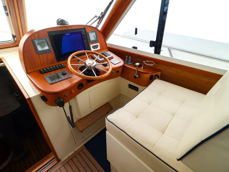 Slide: The Image of Helm of 2009 Legacy 32 boat with wooden dashboard and navigation equipment. - 4