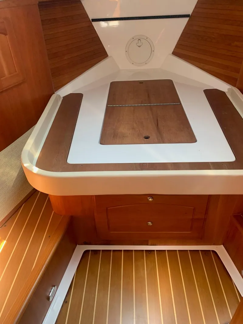 Slide: The Image of Interior of 2009 Legacy 32 boat with wooden flooring and storage compartments. - 47