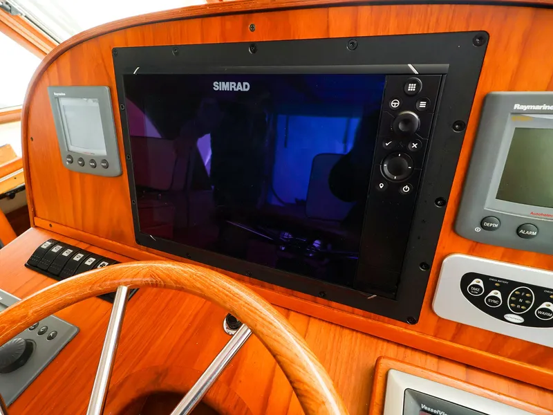Slide: The Image of Control panel of a 2009 Legacy 32 boat with Simrad navigation system. - 5