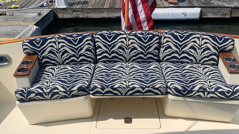 Slide: The Image of Zebra-patterned seating on a 2009 Legacy 32 boat, docked with an American flag. - 7