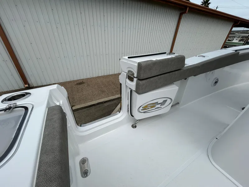 Slide: The Image of 2025 Sea Hunt Gamefish 27 boat interior with coffin box, featuring sleek white design. - 11