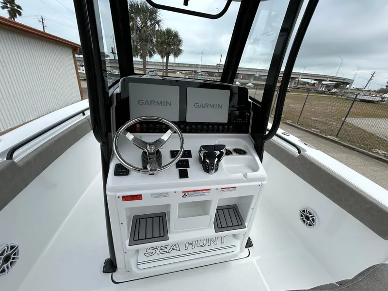 Slide: The Image of 2025 Sea Hunt Gamefish 27 helm with Garmin displays and steering wheel. - 14