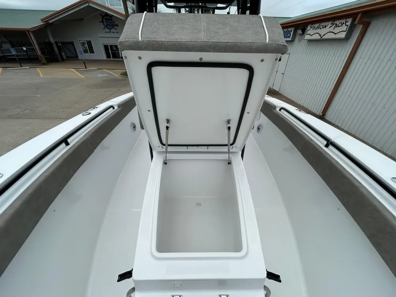 Slide: The Image of 2025 Sea Hunt Gamefish 27 boat with open coffin box, showcasing spacious storage. - 24
