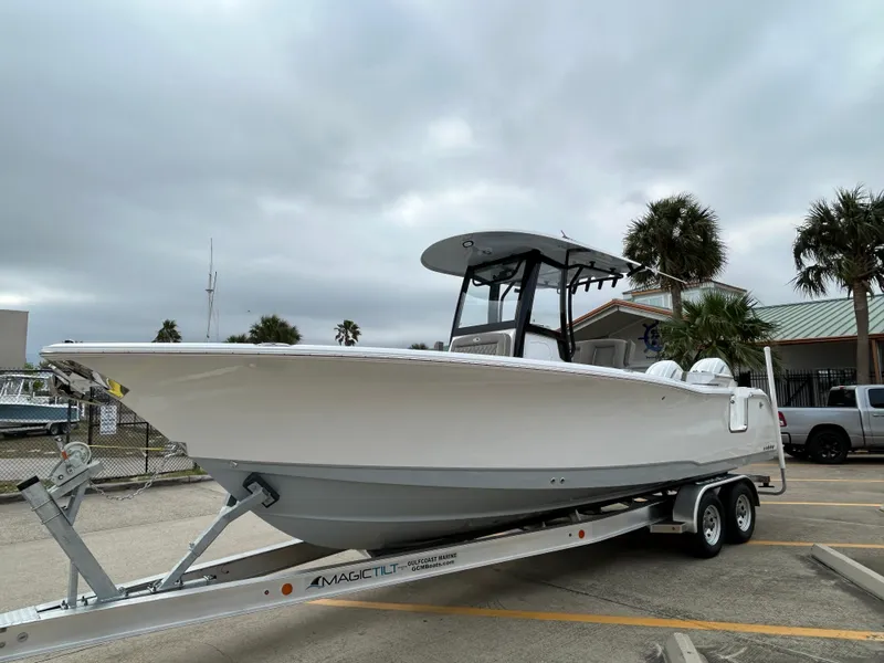Slide: The Image of 2025 Sea Hunt Gamefish 27 with Coffin Box on trailer, parked outdoors. - 3