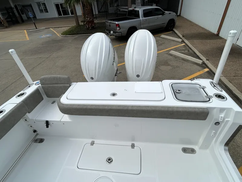 Slide: The Image of 2025 Sea Hunt Gamefish 27 boat with twin engines and coffin box, parked in a lot. - 9
