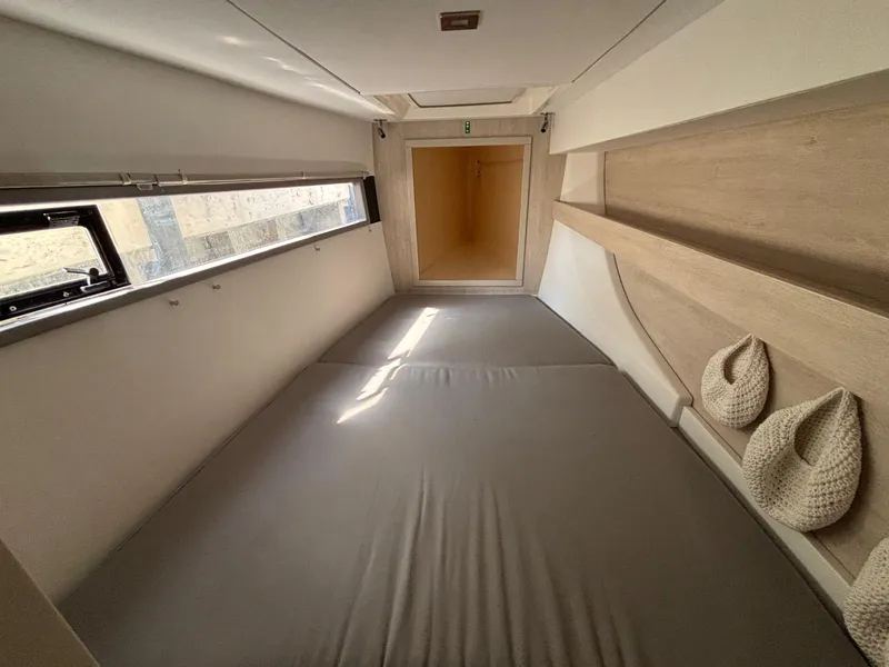 Slide: The Image of Cozy cabin interior of 2019 Leopard 40 catamaran with bed and window. - 10