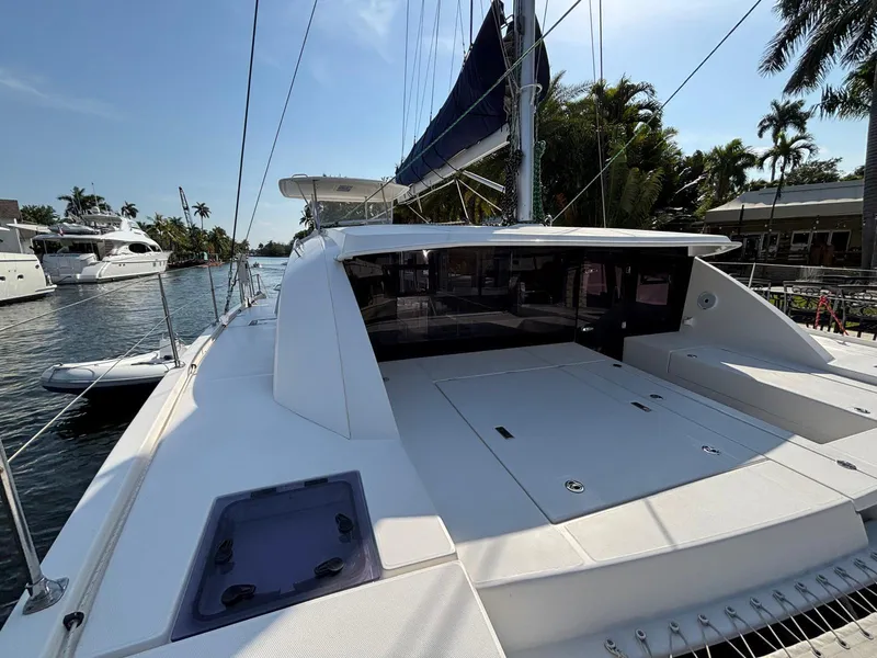 Slide: The Image of 2019 Leopard 40 catamaran docked, showcasing spacious deck and sleek design. - 17
