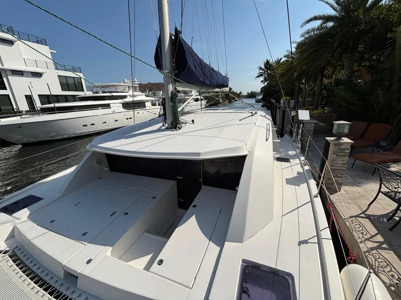 Slide: The Image of 2019 Leopard 40 catamaran docked, showcasing sleek design and spacious deck. - 18