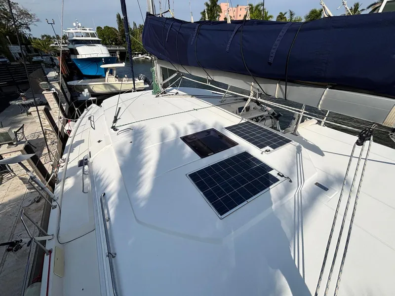 Slide: The Image of Leopard 40 catamaran deck with solar panels, docked in a marina, 2019 model. - 19