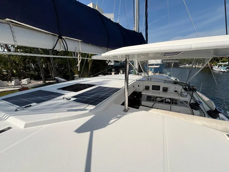 Slide: The Image of 2019 Leopard 40 catamaran with solar panels, docked in a marina under clear skies. - 20