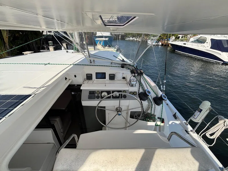 Slide: The Image of 2019 Leopard 40 catamaran cockpit with steering wheel, navigation controls, and marina view. - 21