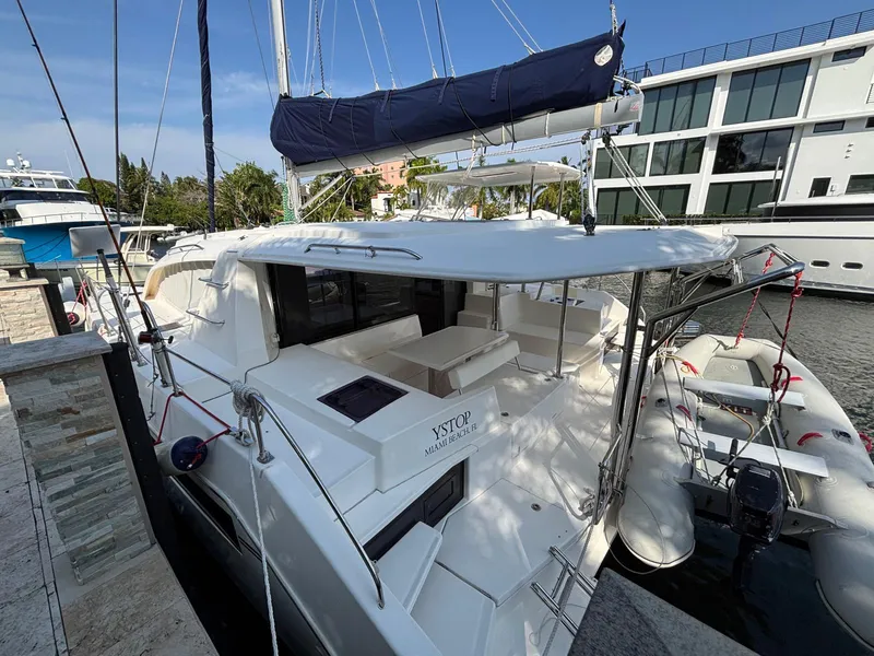 Slide: The Image of 2019 Leopard 40 catamaran docked, featuring spacious deck and modern design. - 24