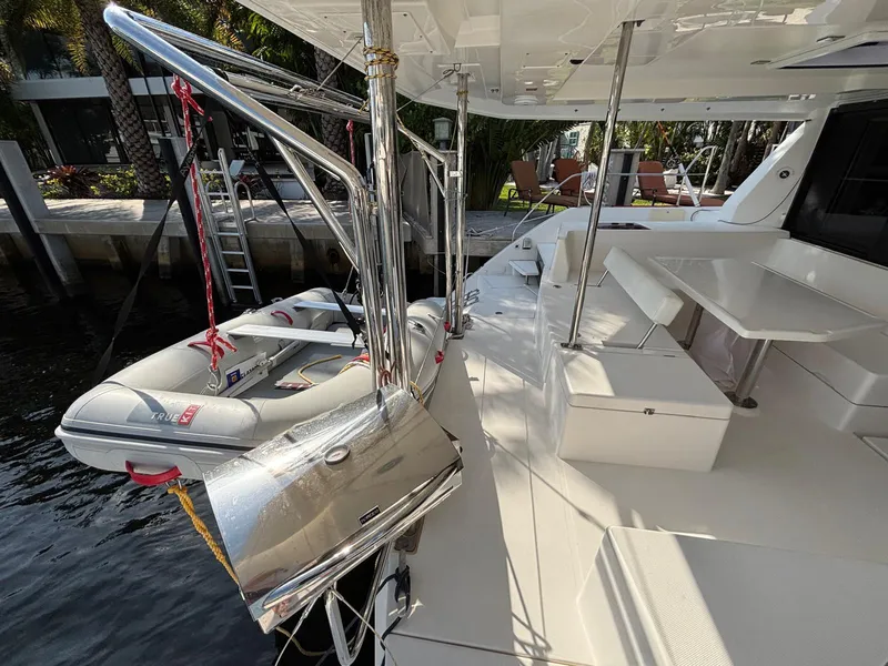 Slide: The Image of Leopard 40 catamaran deck with dinghy, stainless steel davits, and seating area, 2019 model. - 25
