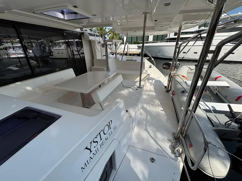 Slide: The Image of 2019 Leopard 40 catamaran deck with seating area, docked in Miami Beach marina. - 27