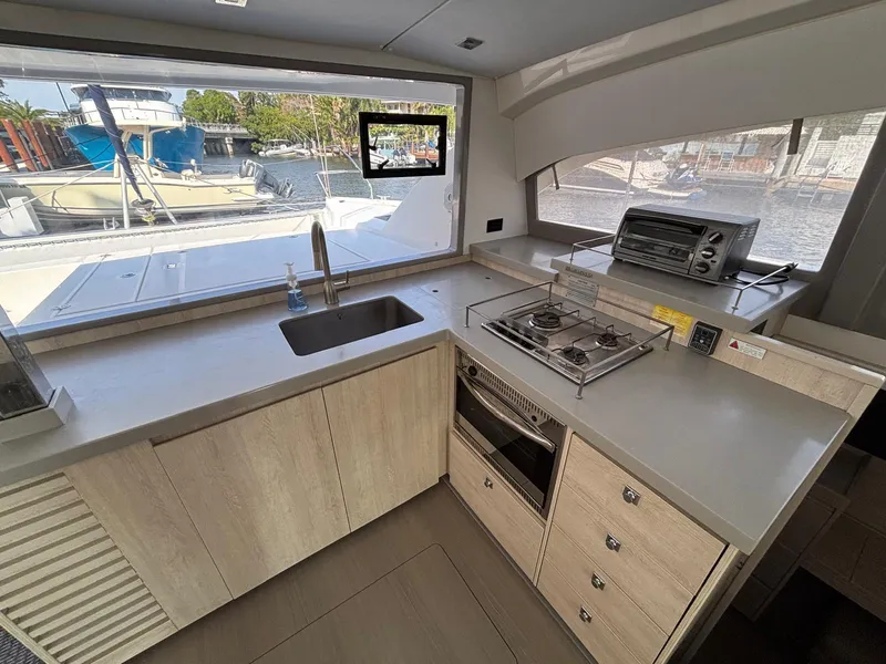 Slide: The Image of Modern kitchen in a 2019 Leopard 40 catamaran with stove, oven, and large windows. - 3