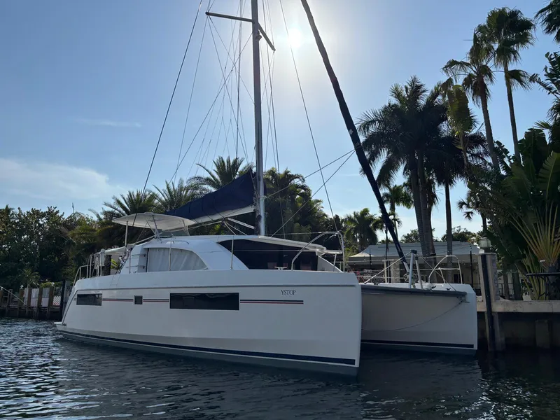 Slide: The Image of 2019 Leopard 40 catamaran docked by palm trees under a clear sky. - 35