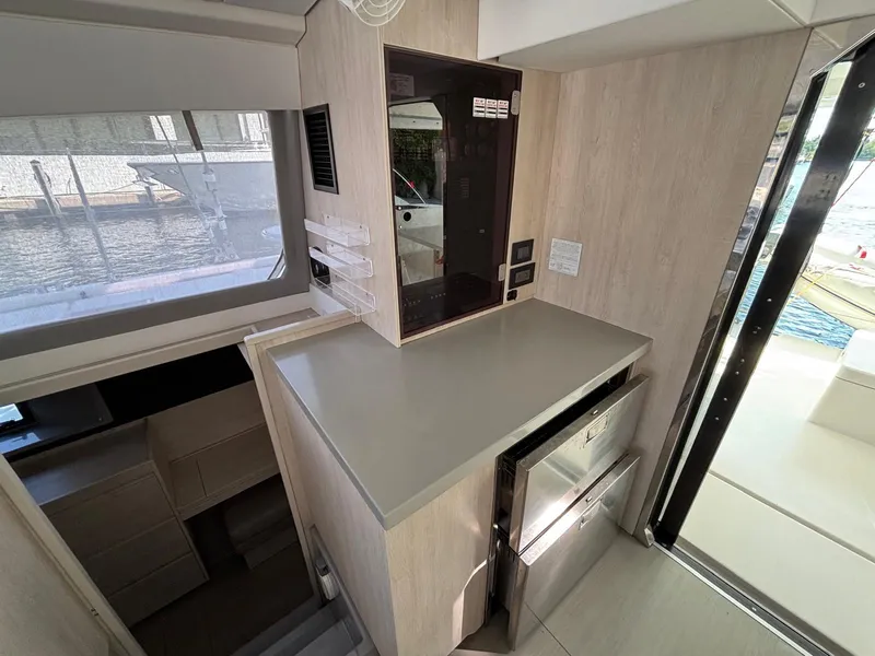 Slide: The Image of Interior of 2019 Leopard 40 yacht, featuring modern kitchen area with sleek cabinetry and appliances. - 4