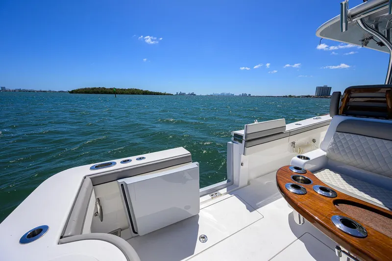 Slide: The Image of 2023 Valhalla Boatworks V-41 on open water, featuring luxurious seating and clear blue skies. - 31