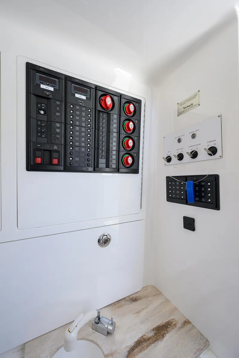 Slide: The Image of Electrical panel inside 2023 Valhalla Boatworks V-41, featuring switches and controls. - 39