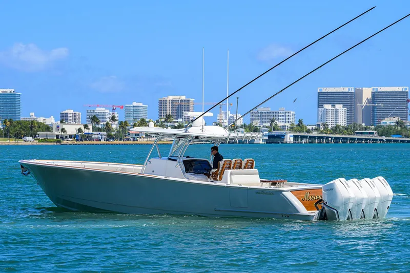Slide: The Image of 2023 Valhalla Boatworks V-41 cruising on blue water with city skyline backdrop. - 5