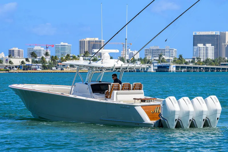 Slide: The Image of 2023 Valhalla Boatworks V-41 cruising in a city harbor with four outboard engines. - 6