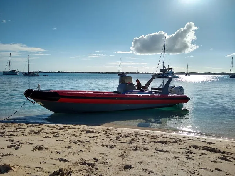 Slide: The Image of Inflatable Rigid boat on sandy beach, calm sea, and clear sky, 2016 model. - 1