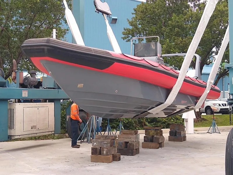 Slide: The Image of Inflatable Rigid boat from 2016 being lifted for maintenance. - 4