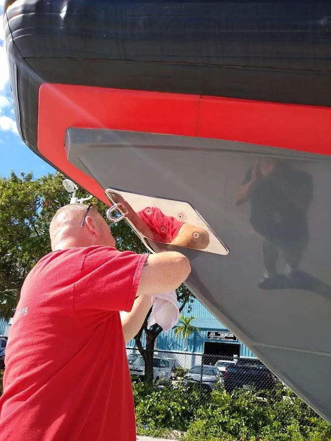Slide: The Image of Man inspecting 2016 Inflatable Rigid boat hull outdoors. - 5