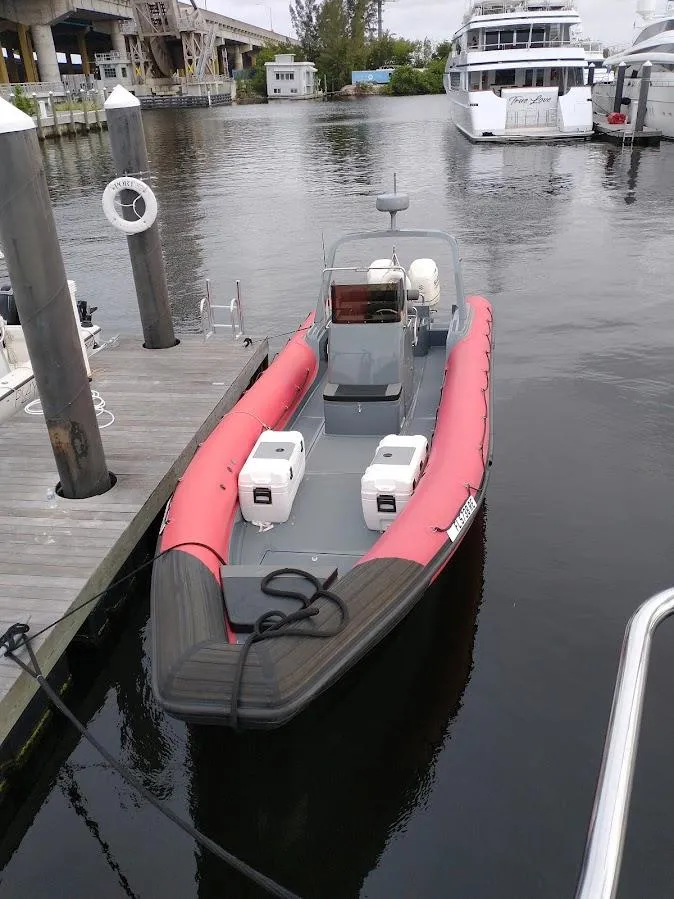 Slide: The Image of Inflatable Rigid boat, 2016 model, docked at marina with twin engines. - 7