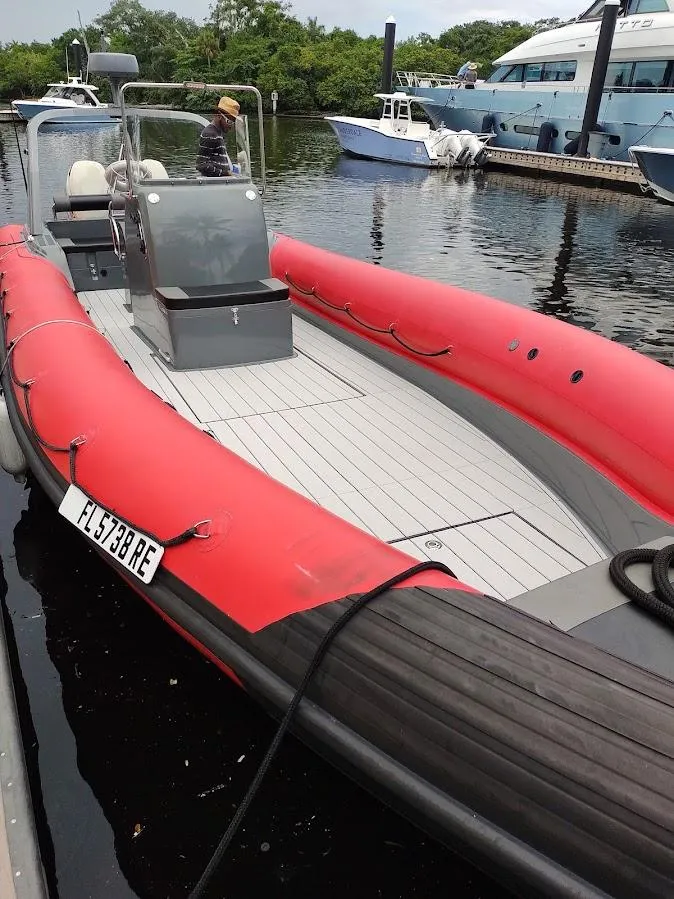 Slide: The Image of Red inflatable rigid boat docked at marina, 2016 model. - 8