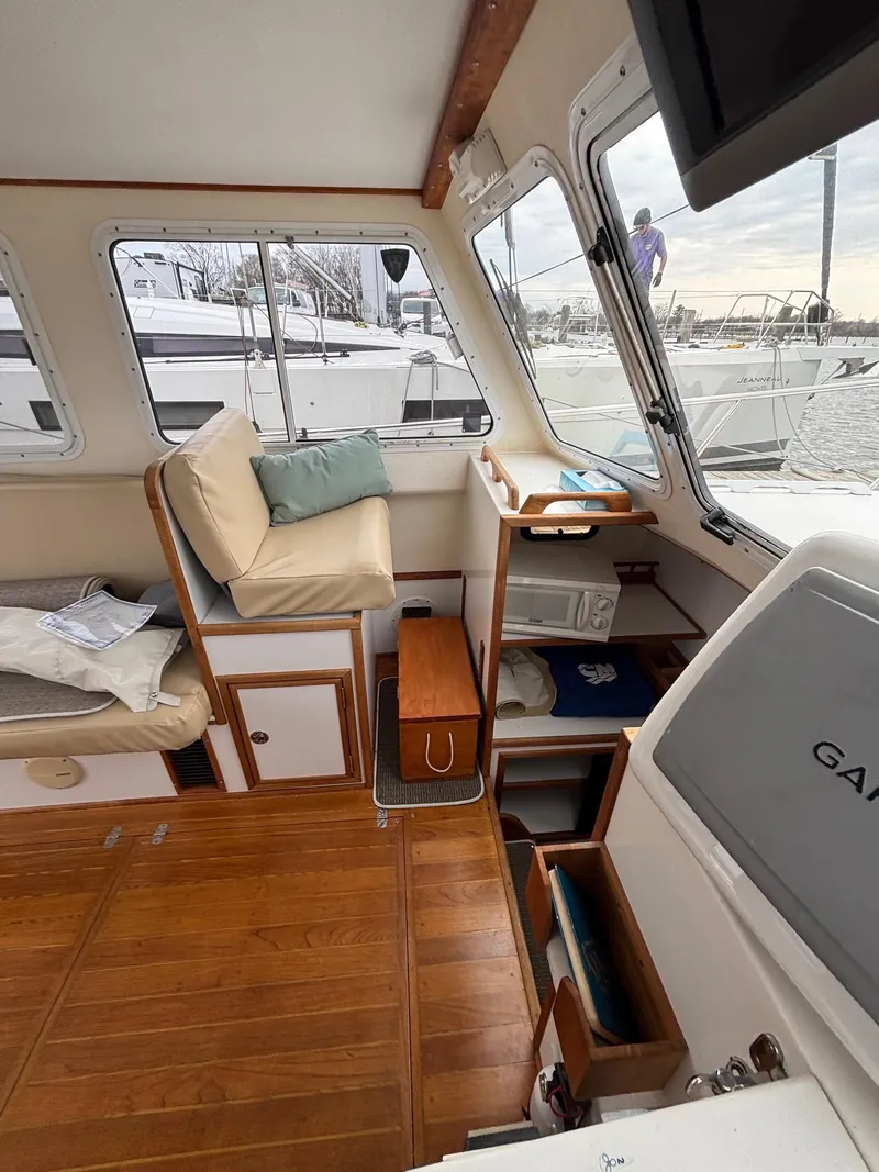 Slide: The Image of Interior of 2008 Eastern Casco Bay 31 boat with wooden flooring and seating area. - 12