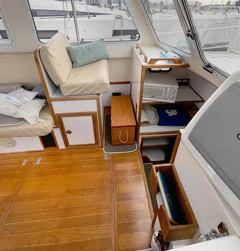 Slide: The Image of Interior of 2008 Eastern Casco Bay 31 boat with wooden flooring and seating area. - 13