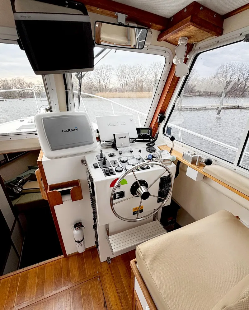 Slide: The Image of 2008 Eastern Casco Bay 31 boat interior with navigation equipment and steering wheel. - 15