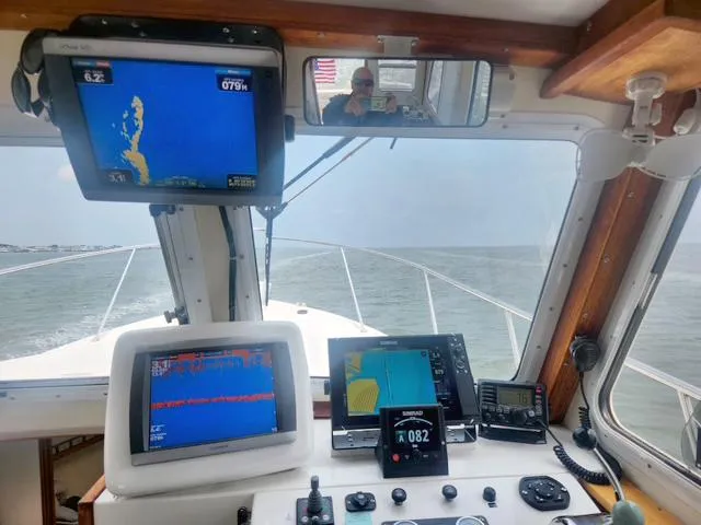 Slide: The Image of 2008 Eastern Casco Bay 31 boat cockpit with navigation screens and ocean view. - 17