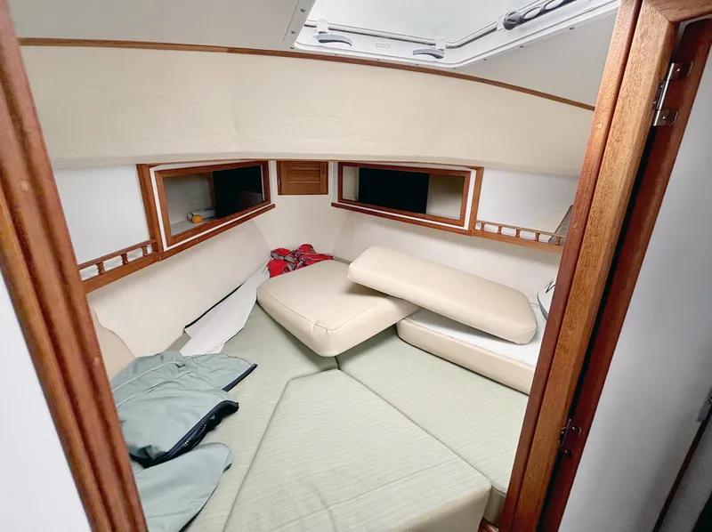 Slide: The Image of 2008 Eastern Casco Bay 31 cabin interior with cushions and wooden accents. - 18