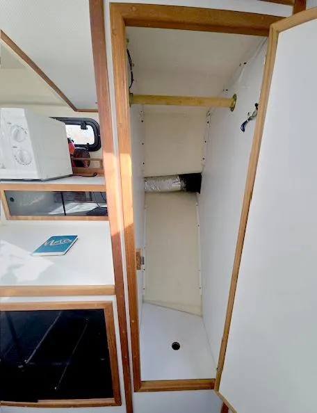 Slide: The Image of 2008 Eastern Casco Bay 31 interior with wooden trim and storage compartment. - 21