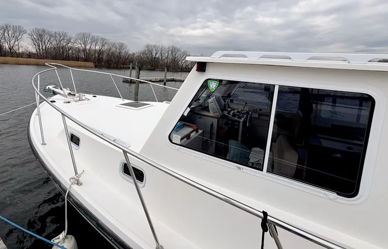 Slide: The Image of 2008 Eastern Casco Bay 31 boat docked on a cloudy day. - 5