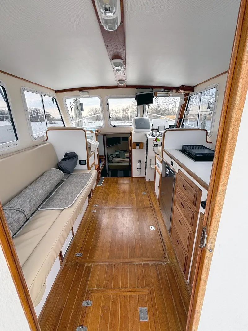Slide: The Image of Interior of 2008 Eastern Casco Bay 31 boat with wooden flooring and seating. - 7