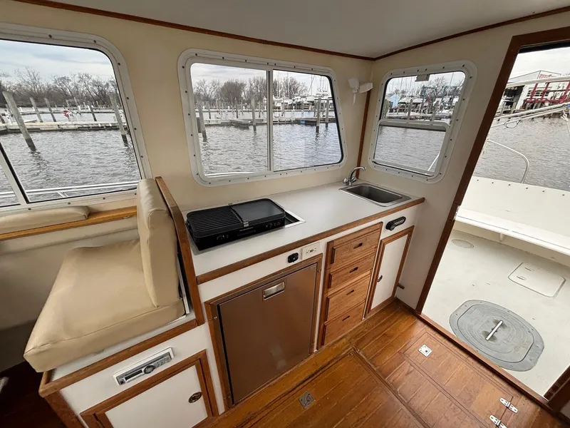 Slide: The Image of Interior of 2008 Eastern Casco Bay 31 boat with kitchenette and seating area. - 8