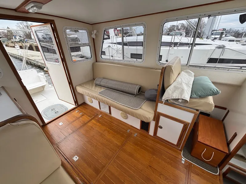 Slide: The Image of Interior of 2008 Eastern Casco Bay 31 boat with wooden flooring and cushioned seating. - 9