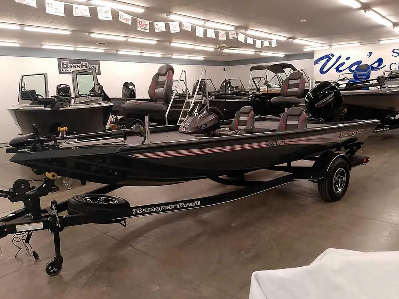 The Image of 2025 Ranger RT178 SC boat in showroom, sleek design, black exterior, trailer included. - 0