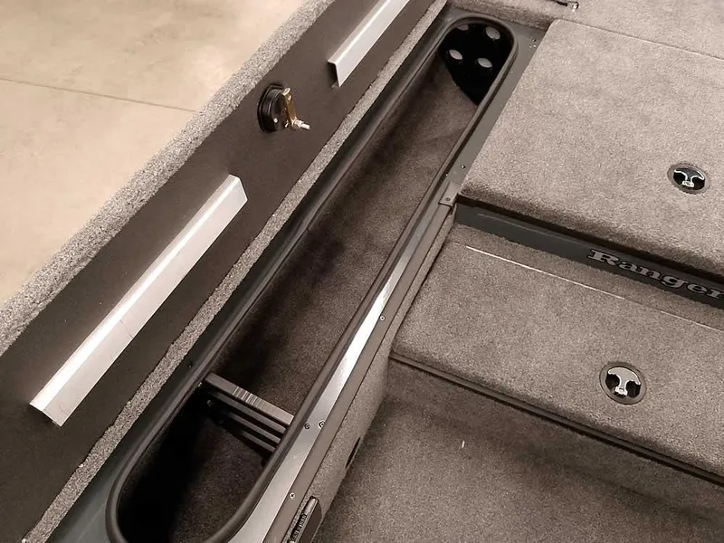 Slide: The Image of 2025 Ranger RT178 SC boat interior with storage compartments and carpeted flooring. - 15