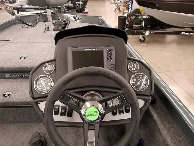 Slide: The Image of 2025 Ranger RT178 SC boat dashboard with steering wheel and Lowrance display. - 25