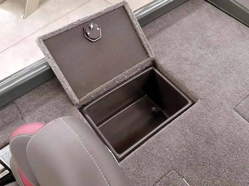 Slide: The Image of 2025 Ranger RT178 SC boat storage compartment with open lid, gray interior, and adjacent seat. - 29